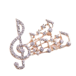 Élégante broche dorée en forme de note de musique avec strass et motif de clé de sol