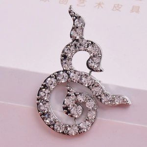 Elegant silver-toned spiral brooch with sparkling rhinestones inspired by Thai culture