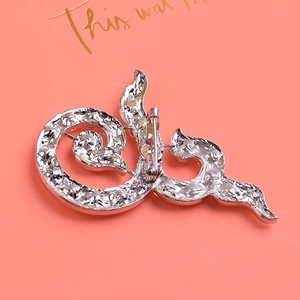 Detailed back view of silver alloy brooch showing the safety pin clasp and metal texture