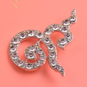 Macro shot of Thai number nine brooch with silver plating and white rhinestones