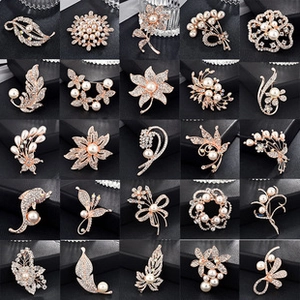 Detailed collection of 25 elegant gold alloy brooches with sparkling crystals and pearls