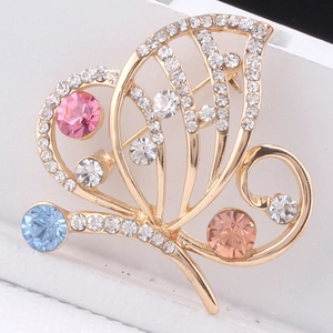Close-up of colorful crystal butterfly brooch with sparkling rhinestones and gold plating