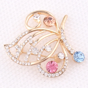 Close-up of butterfly brooch with colorful crystals and gold-plated alloy base