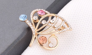 Detailed macro view of colorful butterfly brooch with crystals and gold plated metal
