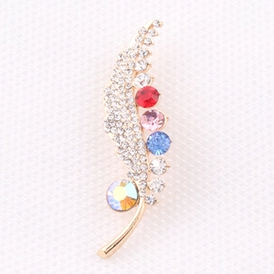 Elegant gold feather brooch featuring colorful crystals and sparkling white rhinestones