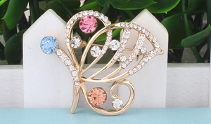 Detail of colorful butterfly brooch with multi-colored crystals and diamond accents