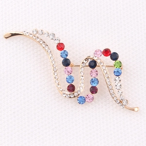 Detail view of colorful crystal wave brooch with gold plating and sparkling rhinestones