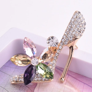 Close-up of high heel brooch with multi-color crystals and white rhinestones on alloy