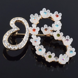 Detailansicht der herzförmigen Gold-Blumenbrosche mit bunten Kristallen und Strass