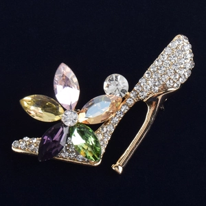 Detailed close-up of a high heel brooch featuring colorful crystals and shiny rhinestones
