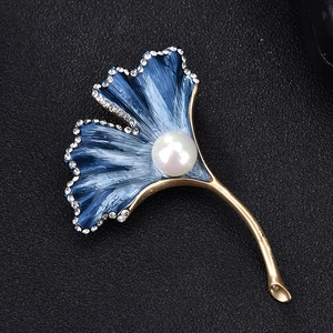 Detail of ginkgo leaf brooch with blue gradient enamel and sparkling white rhinestones