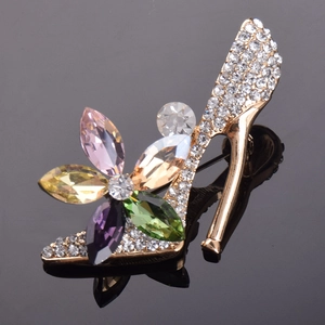 Elegant high heel brooch with colorful crystals and sparkling white rhinestones on gold base