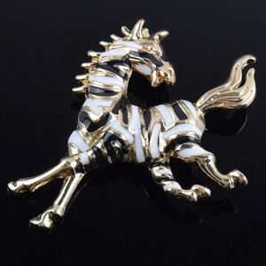 Elegant gold-tone zebra brooch with black and white enamel stripes in running pose