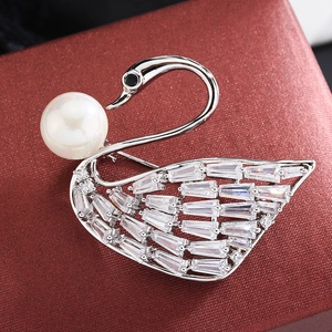 Elegant silver swan brooch with white pearl and sparkling cubic zirconia on a red box