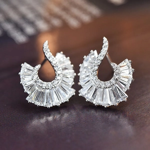 Macro shot of silver fan-shaped earrings with pave-set baguette and round zircons