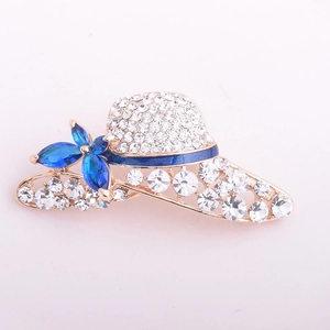 Detail of crystal sun hat brooch with blue floral gem and gold plated finish