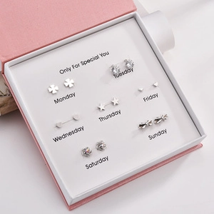 7-day earrings gift set featuring clover, star, and heart studs in a pink box