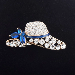 Fashionable golden hat brooch with sparkling crystals and blue floral accents for suits