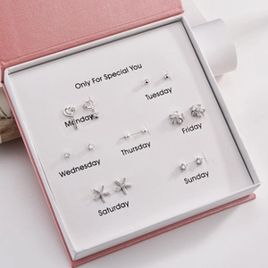 Detailed view of 7-pair sterling silver earring set in elegant pink gift box packaging