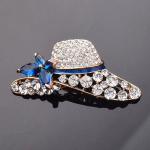 Detail of sun hat brooch with gold metal base, white rhinestones and blue crystals