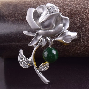 Broche fleur argentée élégante avec perle d'ambre verte et détails en cristal
