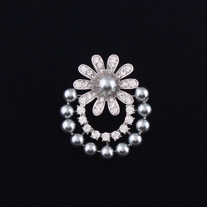Elegant silver flower brooch featuring gray pearls and shimmering crystals on black velvet