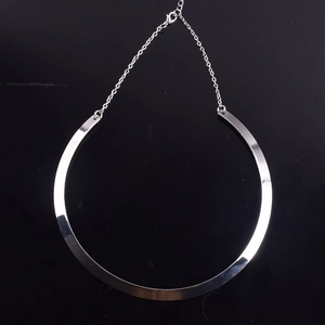Detailed macro view of punk style silver metal choker with adjustable lobster clasp chain