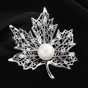 Elegant silver maple leaf brooch with a large white pearl and sparkling zircon accents