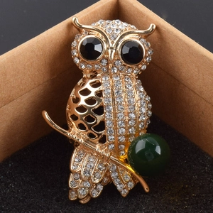 Sparkling owl brooch in gold metal with white rhinestones and a green bead accent