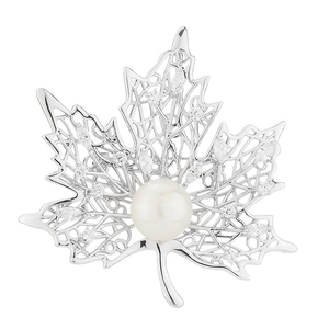 Silver maple leaf brooch with crystal mesh wings and center pearl on white background