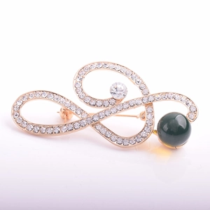 Elegant gold musical note brooch with sparkling crystals and deep green pearl accent