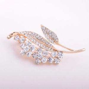 Elegant gold crystal flower brooch with sparkling rhinestones on a white background