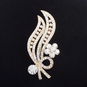 Macro shot of gold leaf brooch with brilliant rhinestones and sparkling floral details