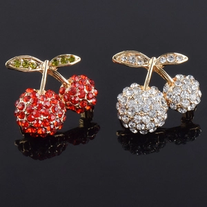 Exquisite red and white crystal cherry brooches set with gold plating on a black reflective base