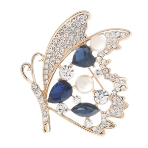 Broche papillon dorée avec cristaux bleu foncé, perles blanches et strass étincelants