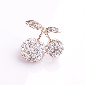 Detailed view of cherry brooch with rose gold setting and sparkling pavé crystals