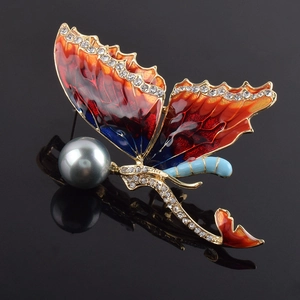 Detailed shot of mermaid butterfly brooch with enamel wings and gray-blue pearl