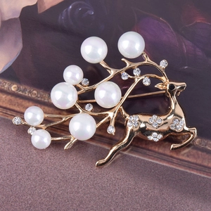Elegant gold reindeer brooch with white pearls and sparkling floral crystal details