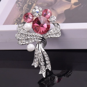 Detail of flower brooch with pink crystals and pearls on silver alloy base