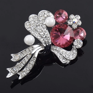 Elegant floral bouquet brooch with pink crystals and pearls on a black background