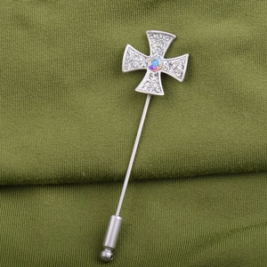 Silver cross stick pin with crystal pavé and AB stone on green ribbed fabric