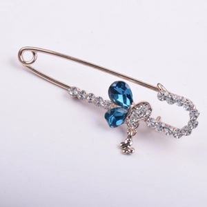 Golden butterfly safety pin brooch with blue water drop crystals and heart pendant