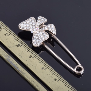 Sparkling rhinestone butterfly brooch in rose gold with safety pin and ruler reference