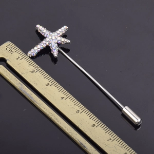 Elegant starfish rhinestone brooch with long silver needle and ruler for size reference