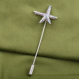 Close-up of starfish stick pin brooch with AB colorful rhinestones on olive knit fabric