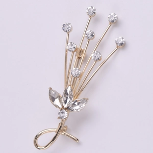 Elegant gold spark crystal bouquet brooch with shimmering rhinestones on gray background