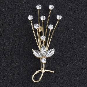 Detail view of flower bouquet brooch with sparkling crystals and golden metal finish