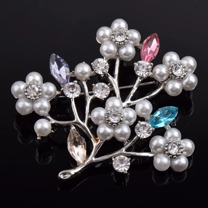 Elegant silver flower brooch with white pearls and colorful crystals on black mirror background