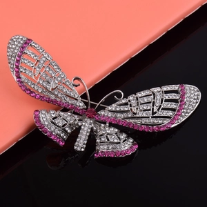 Detail of alloy butterfly brooch with pink and white rhinestones on silver plating