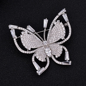 Detailed close-up of butterfly brooch with silver base and sparkling cubic zirconia stones